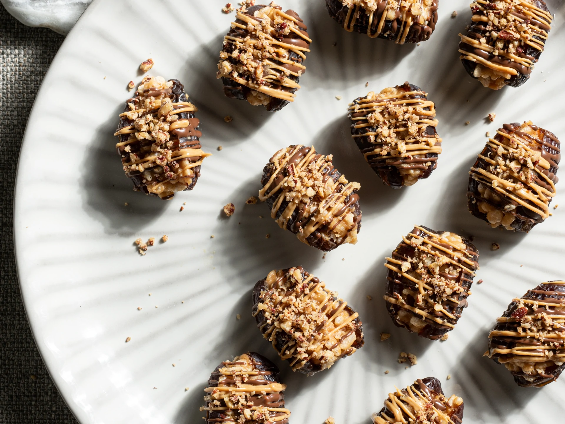 Chocolate-Drizzled Peanut Chew-Stuffed Dates with Nut Crunch